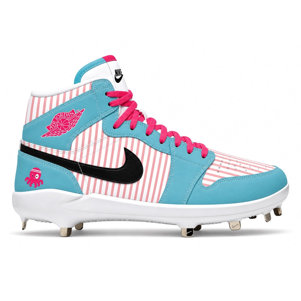 Blue and pink cleated shoe with a white sole on a white background