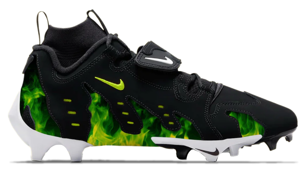 Black and green cleat with a prominent Nike logo on a white background
