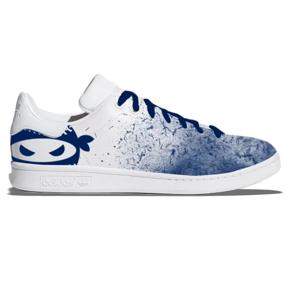 White Adidas Stan Smith sneaker featuring a blue Ninja design from Pitching Ninja Navy Blizzard