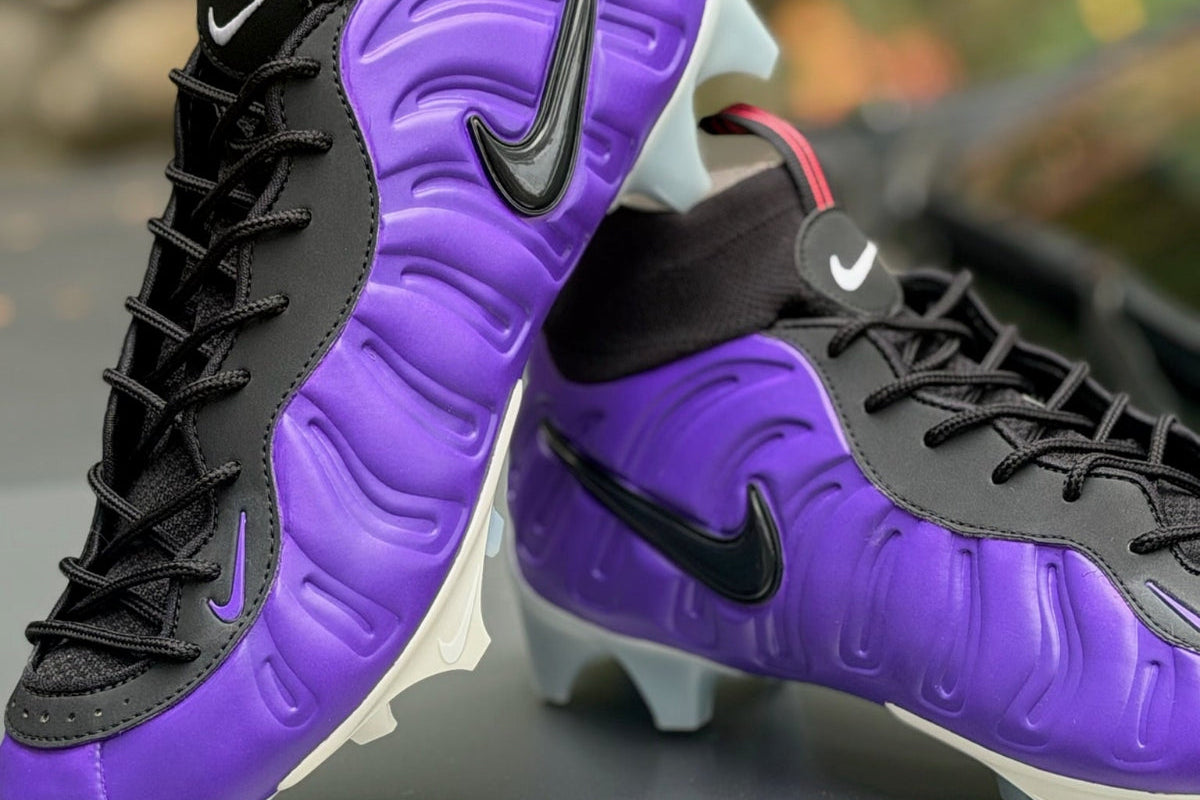 Purple and black custom Nike Vaporposite football cleats.