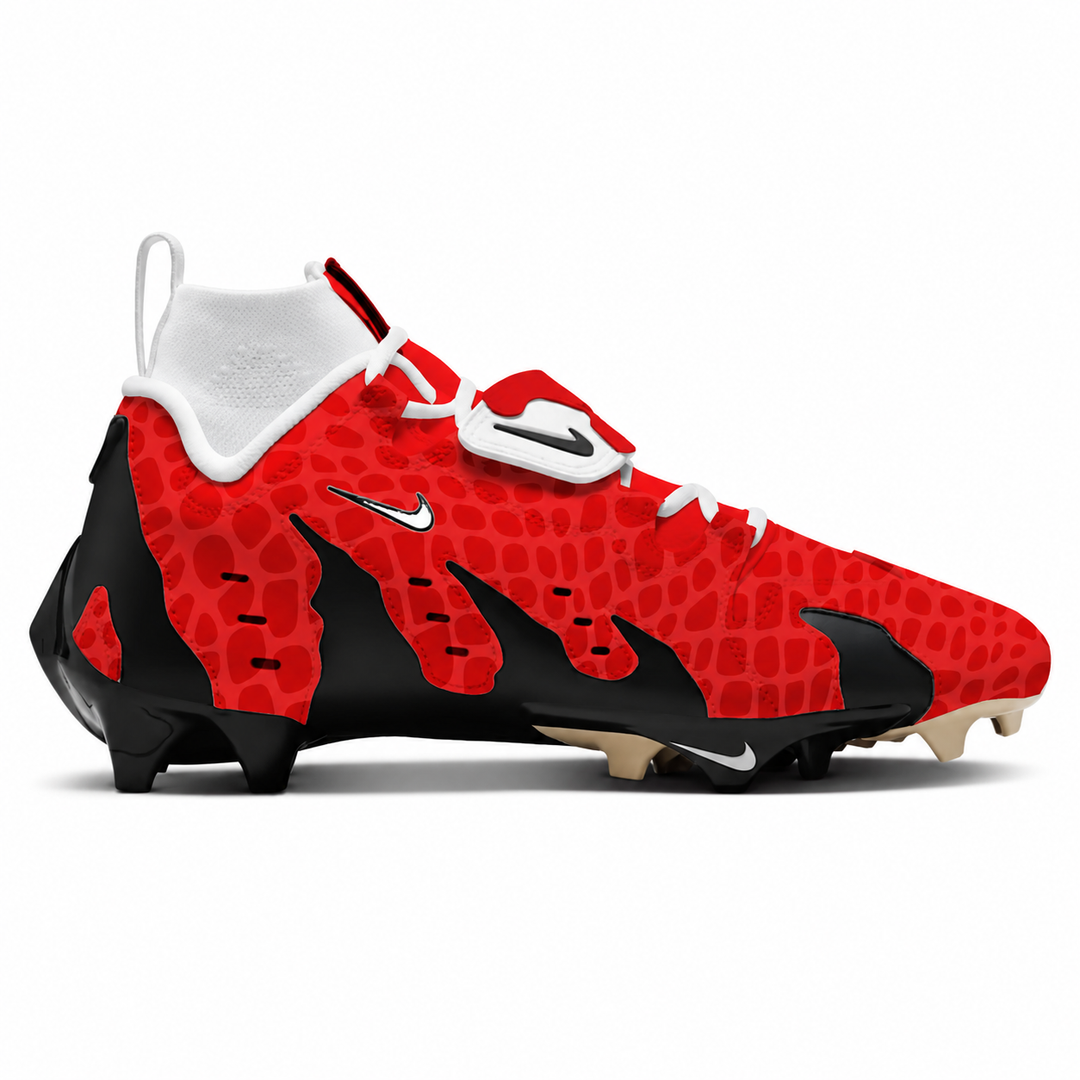 A Nike football cleat in a vibrant red and black patterned design with white accents, shown in a side profile on a white background.