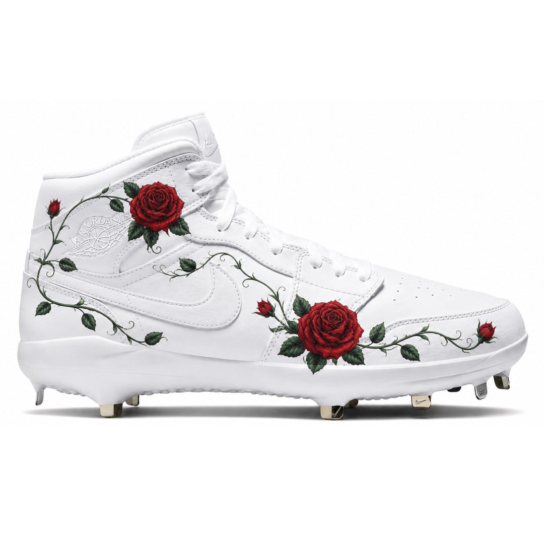 Custom white Jordan 1 Retro cleats featuring hand-painted red roses and vine detailing with spikes — by Stadium Custom Kicks
