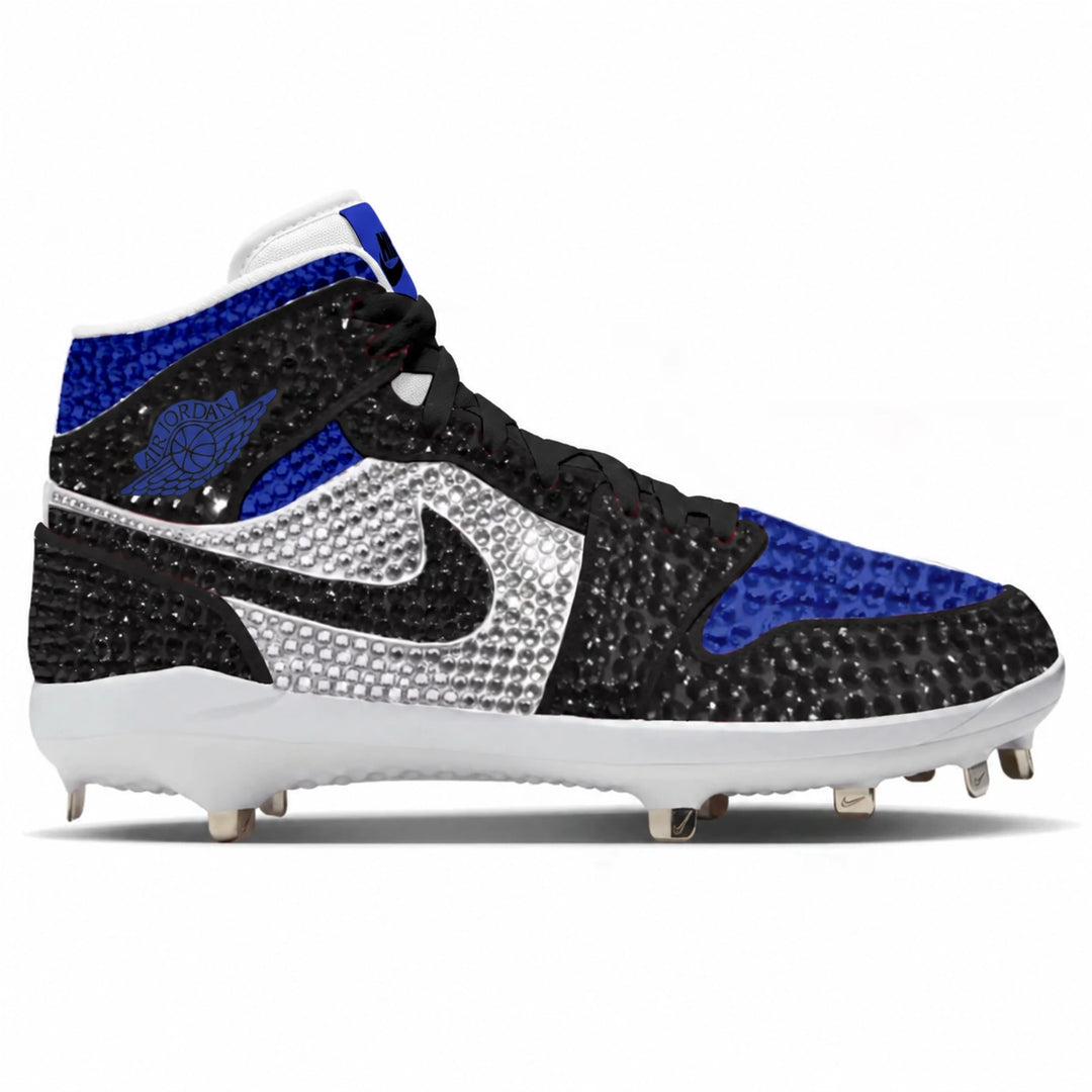 A high-top baseball cleat featuring a black rhinestone-embellished upper, royal blue panels, a silver rhinestone Swoosh, and a white sole with metal studs, shown against a plain white background.