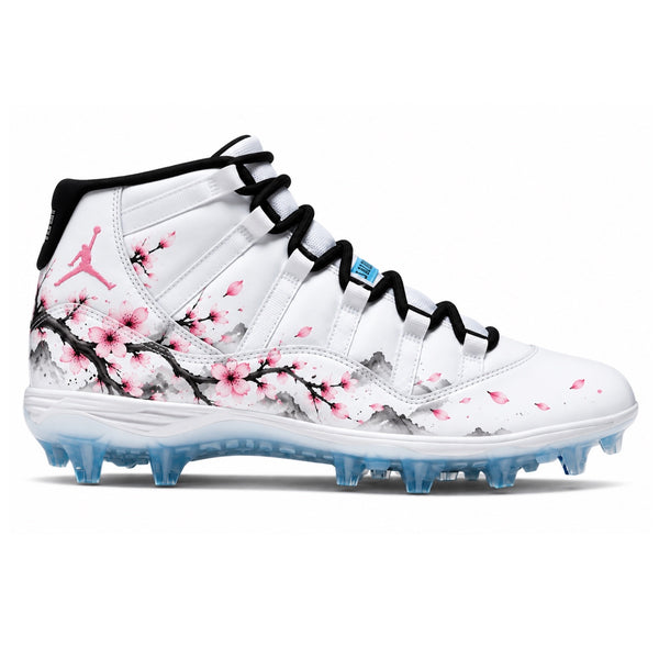 White Jordan 11 TD football cleats with pink cherry blossoms black branches gray ink wash mountains and icy blue sole side view by Stadium Custom Kicks