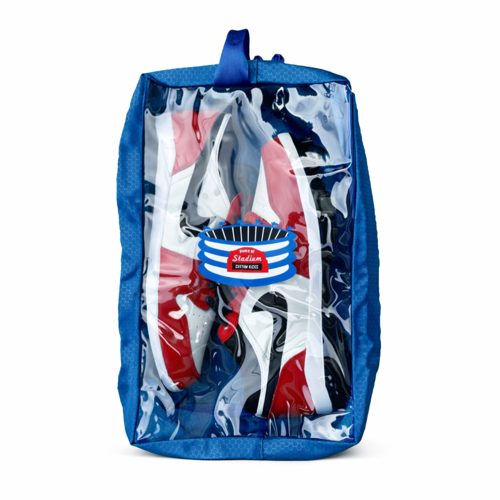 Blue cleat shoe travel bag case with clear plastic cover containing red, white, and blue shoes on a white background