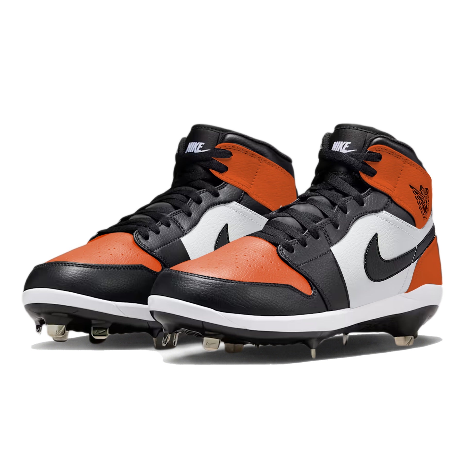 Angled view of Jordan 1 Retro baseball cleats in the Shattered Backboard color way, showcasing orange and black leather panels, white midsole, metal spikes, and hand-painted custom design by Stadium Custom Kicks.