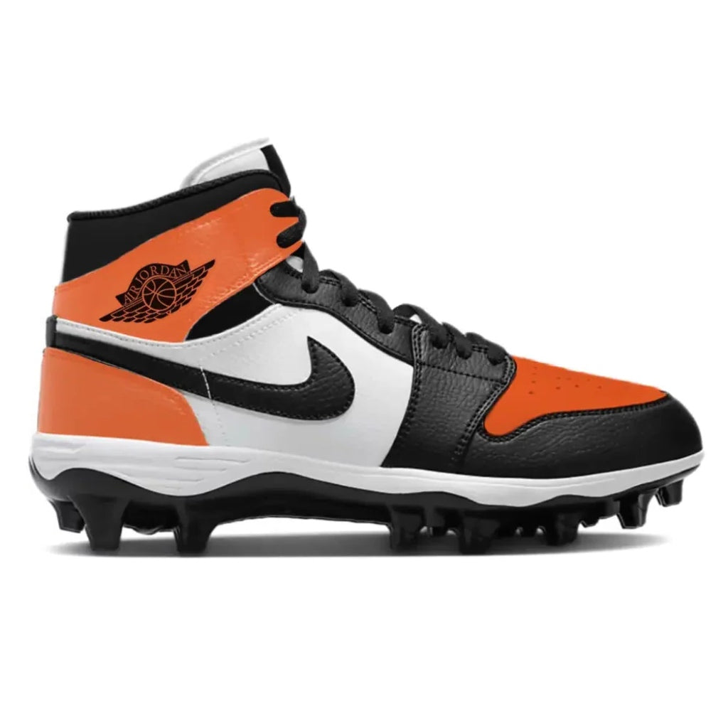 Orange, black, and white cleated shoe on a white background