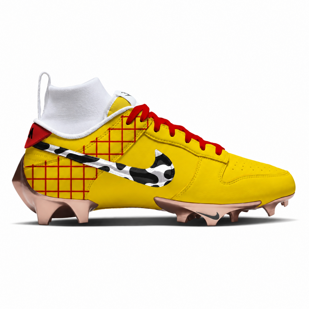 A yellow Nike football cleat featuring a white ankle sock, red laces, a red grid pattern on the heel, a black and white animal print Swoosh, and rose gold cleats, shown against a plain white background.