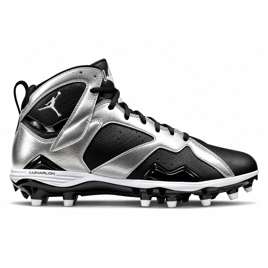 A high-top football cleat in metallic silver and black, featuring the Jumpman logo on the side and heel, with white studs on a clean white background.