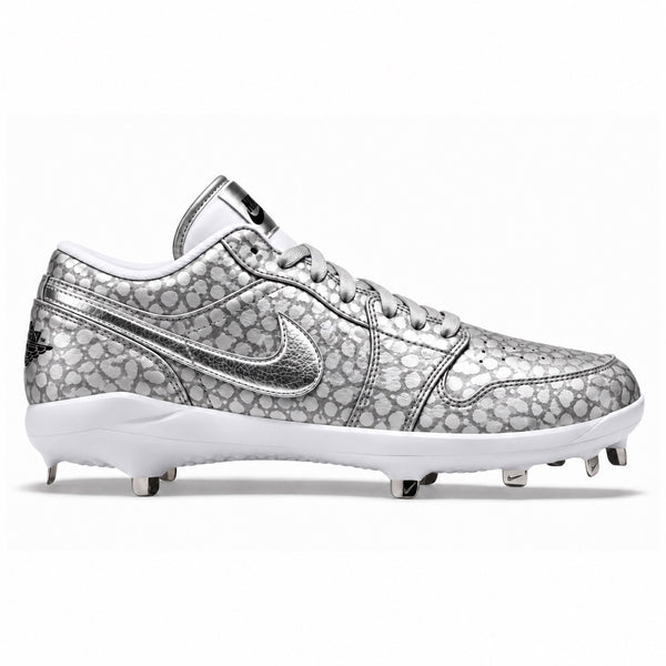 Silver and grey Jordan 1 Retro baseball cleats featuring a metallic spotted pattern, cracked silver Swoosh, matching silver laces, white midsole, and metal spikes by Stadium Custom Kicks.