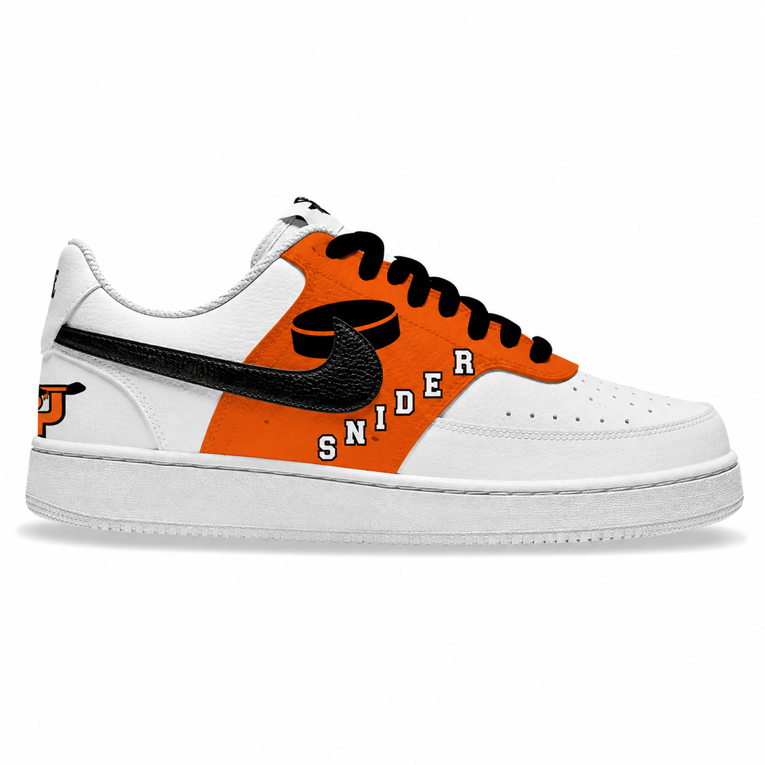 A white low-top sneaker with a bold orange side panel, black swoosh, black laces, and the word 'SNIDER' printed across the side in white and black.