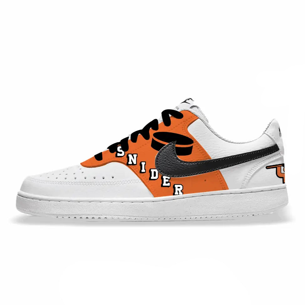White sneaker with orange and black design on a white background