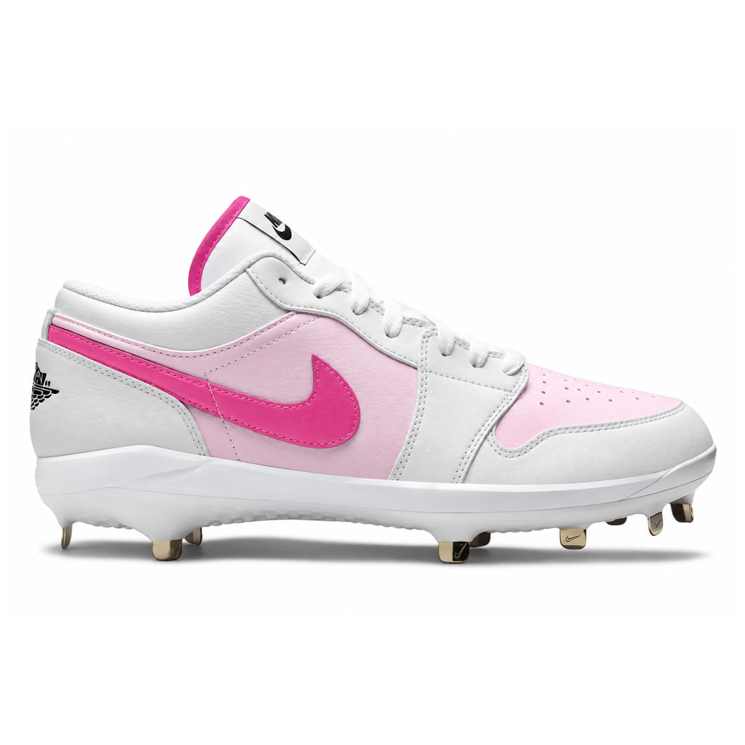 A Nike baseball cleat featuring a white leather upper with light pink and bright pink overlays, white laces, and gold metal studs on a white background.