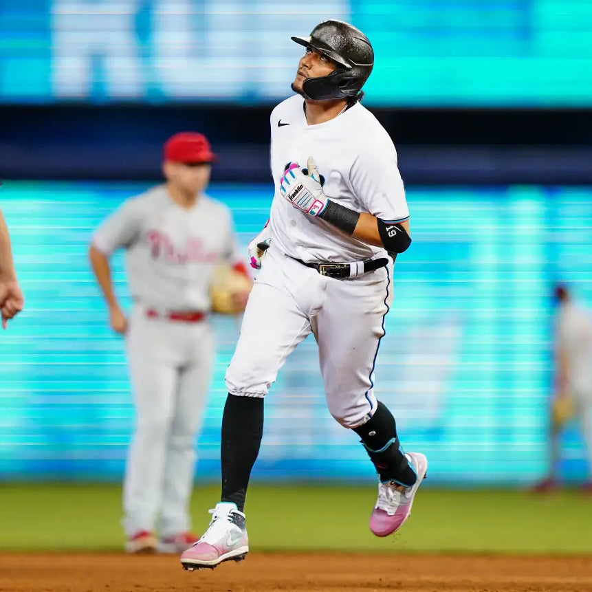 Baseball player running in South Beach Splatter Jordan 1 Retro Cleats