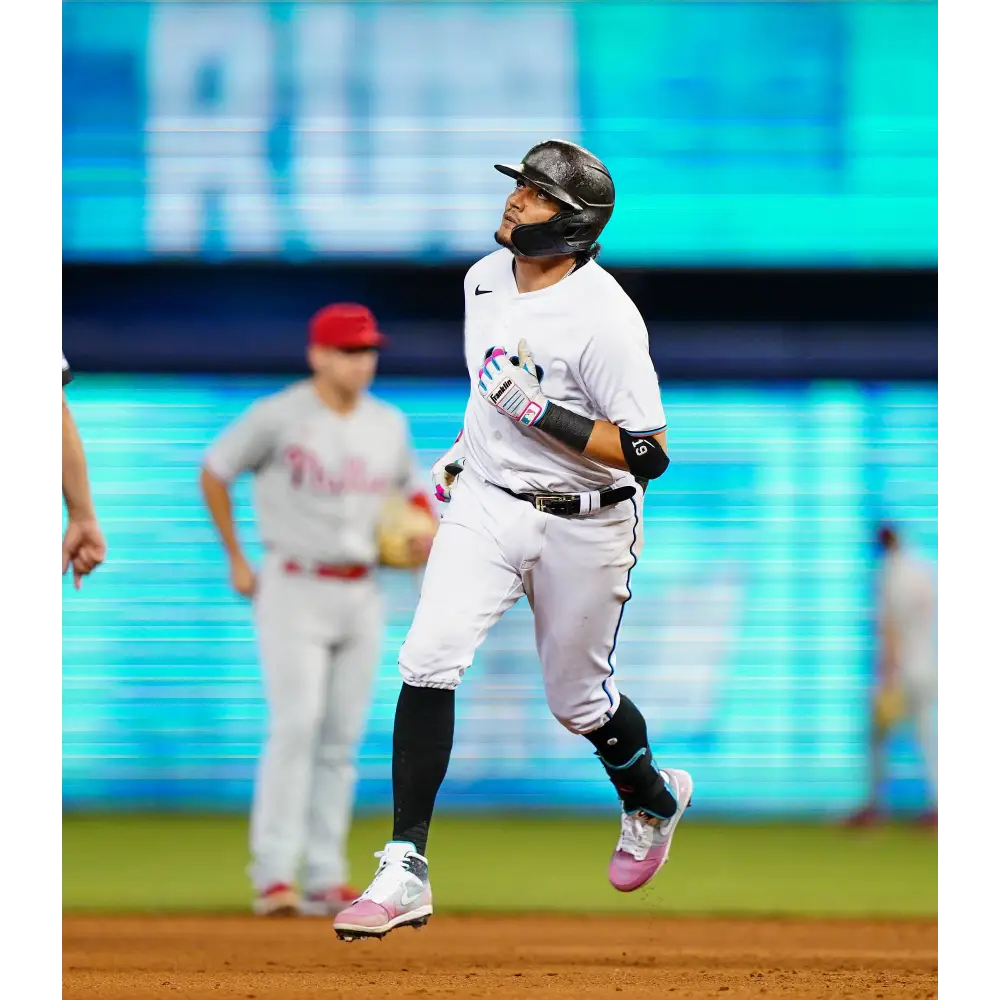 Baseball player running in South Beach Splatter Jordan 1 Retro Cleats