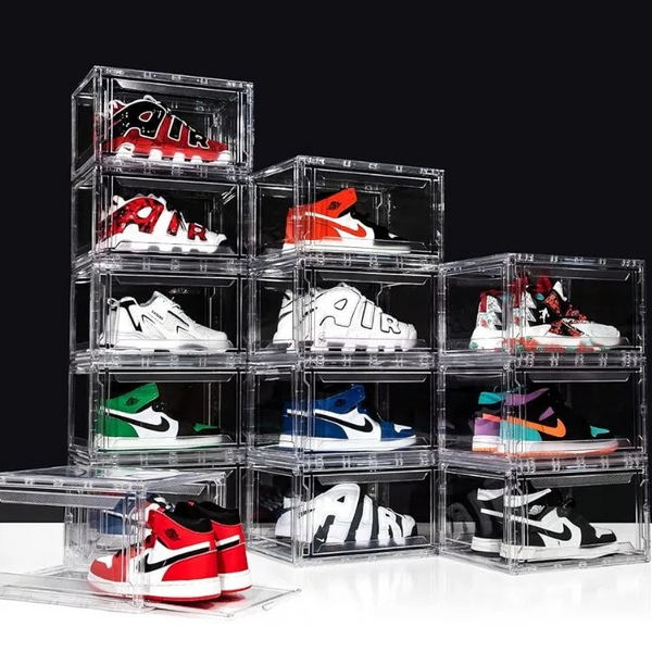 Clear acrylic shoe boxes displaying various sneakers on a white background