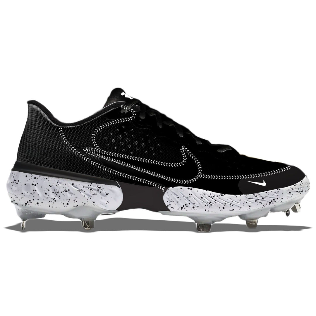Black low top baseball cleats with white baseball seams and black speckles on the midsole.