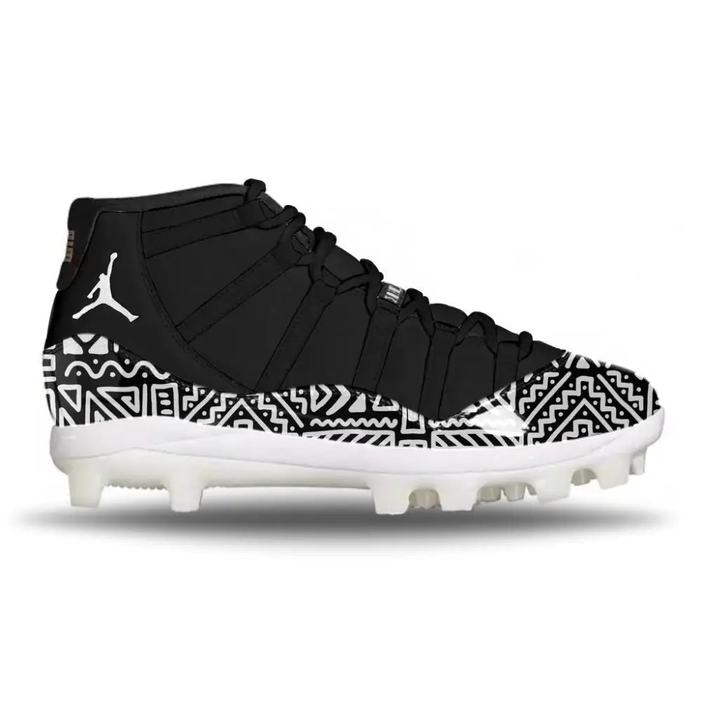 Side view of Jordan 11 Retro MCS baseball cleats in black with white tribal pattern wrap and white outsole
