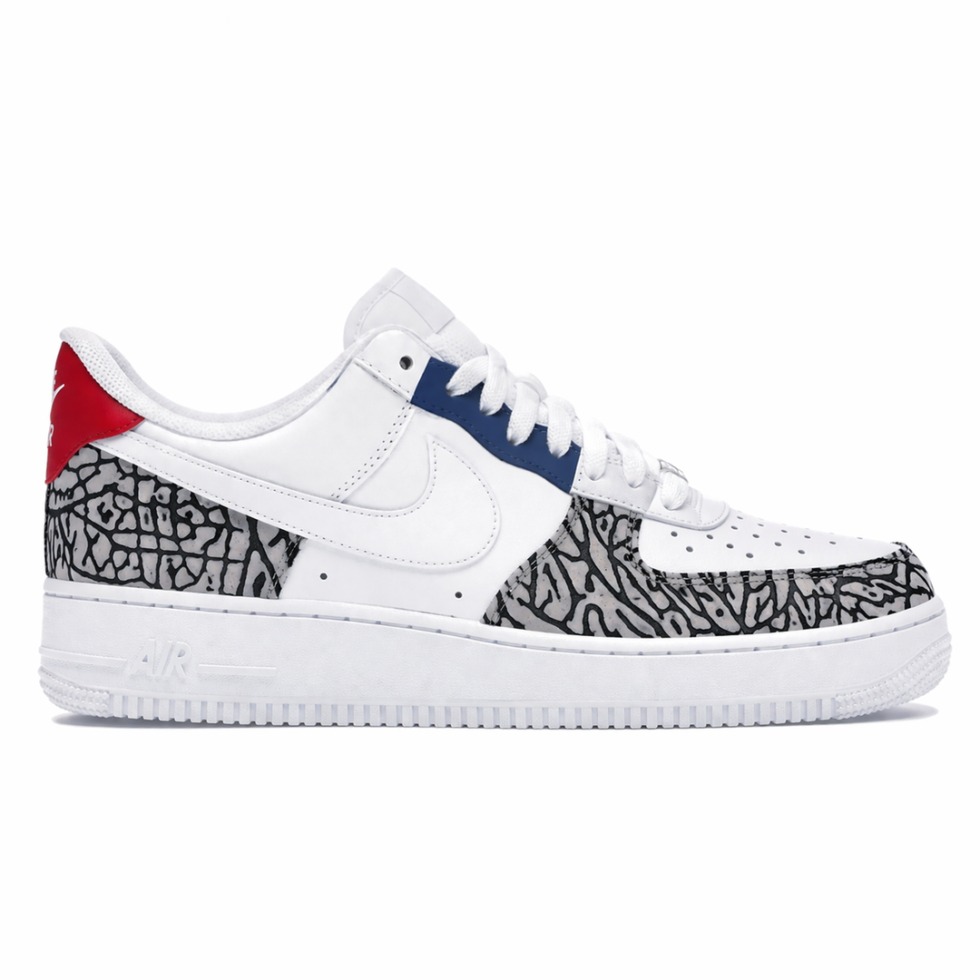White sneaker with black and gray pattern and red and blue accents on a white background