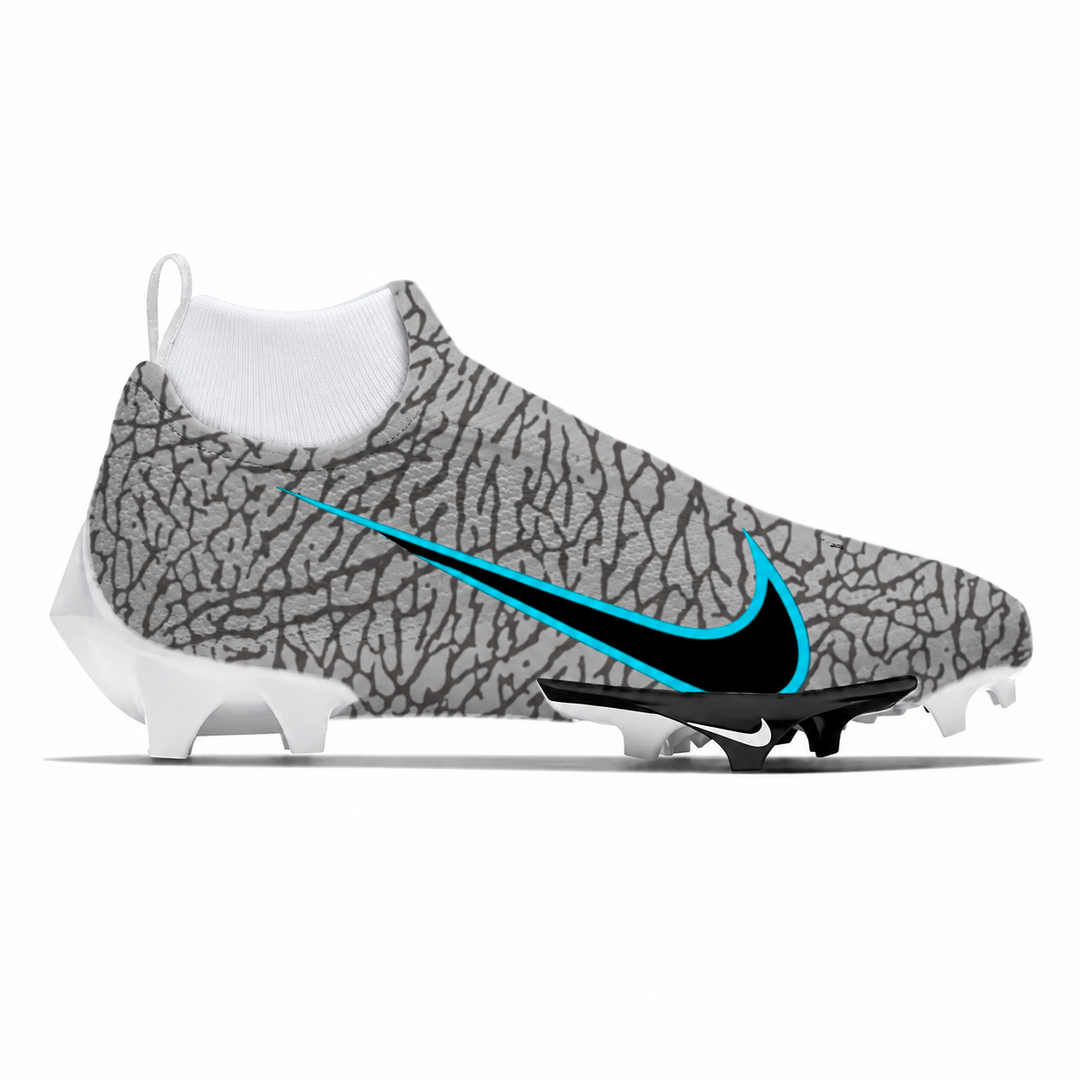 A Nike football cleat featuring a gray and black elephant print upper, a white sock-like collar, a black and bright blue Swoosh, and white studs, shown against a plain white background.