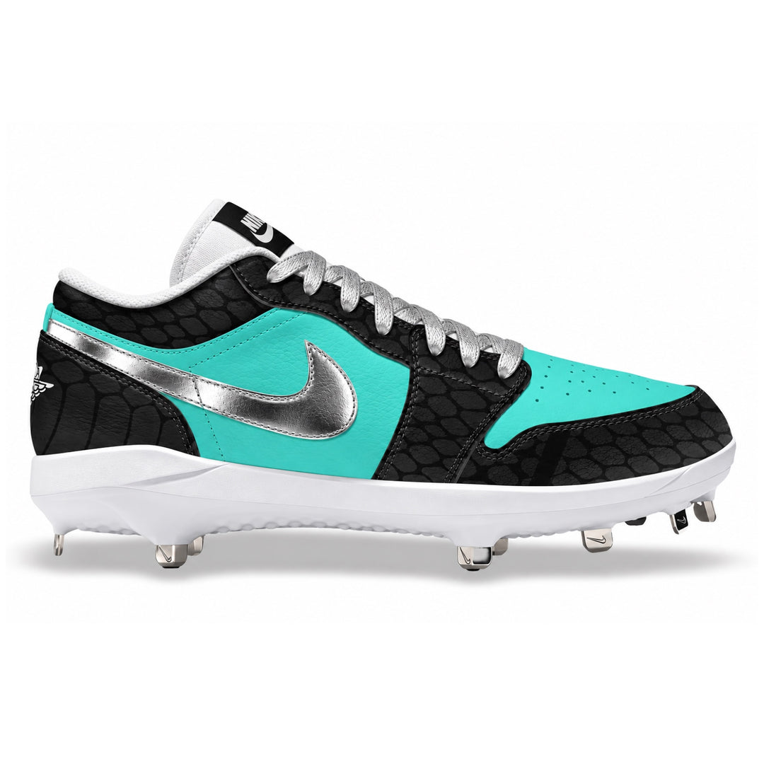 A Nike baseball cleat featuring a black textured crocodile pattern, bright turquoise panels, a metallic silver swoosh, and a white midsole with metal studs, shown against a plain white background.