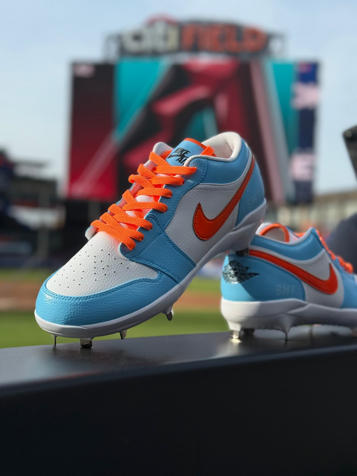 Tyrone Taylor's custom Jordan 1 low top cleats sitting on the dugout railing at Citi Field.