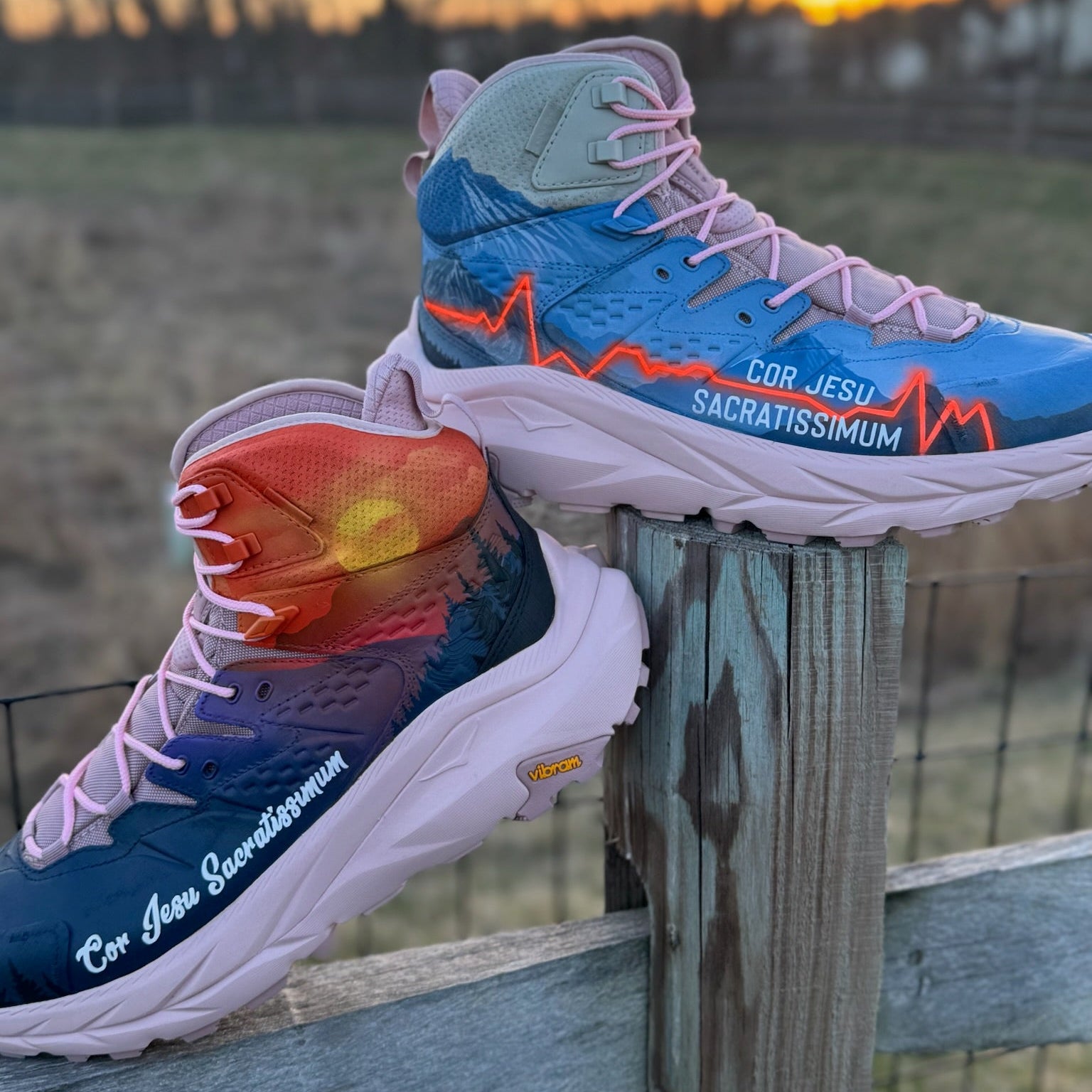 Colorful sneaker boots with text on a wooden fence during sunset.