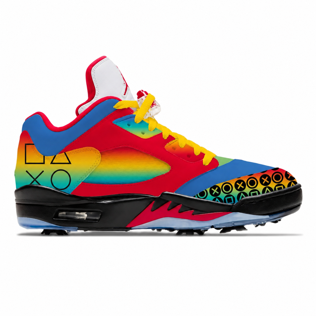 A vibrant, multicolor low-top golf shoe featuring a rainbow gradient, red overlays, yellow laces, and PlayStation-style controller button graphics on the toe box, set against a plain white background.