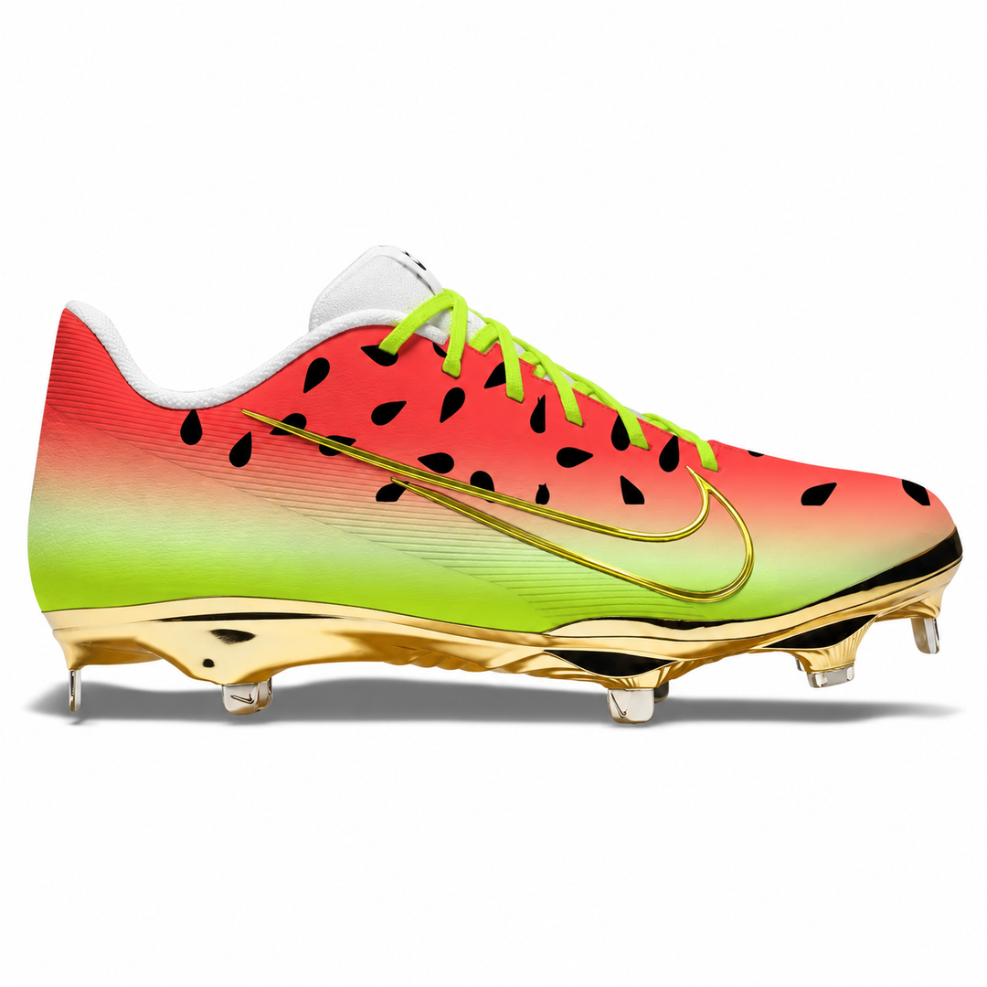 Watermelon-inspired Nike baseball cleat featuring a red-to-neon green gradient, black seed details, lime green laces, white tongue and sockliner, gold Swoosh, and metallic gold soleplate.