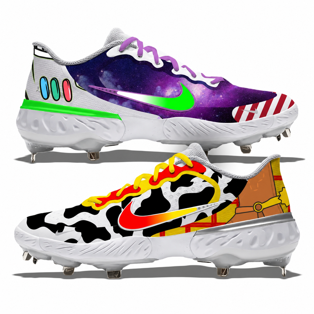 Two custom-designed Nike running shoes with spikes, displayed against a white background. The top shoe features a purple galaxy print with a neon green Swoosh, purple laces, and colorful pastel accents.