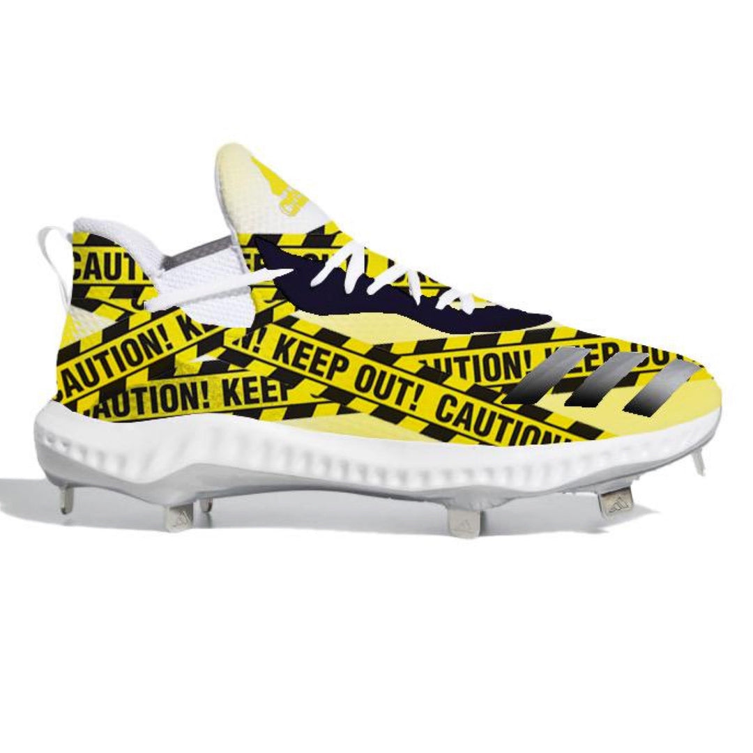 Yellow and black caution tape-themed Adidas Icon V Bounce baseball cleats for bold style